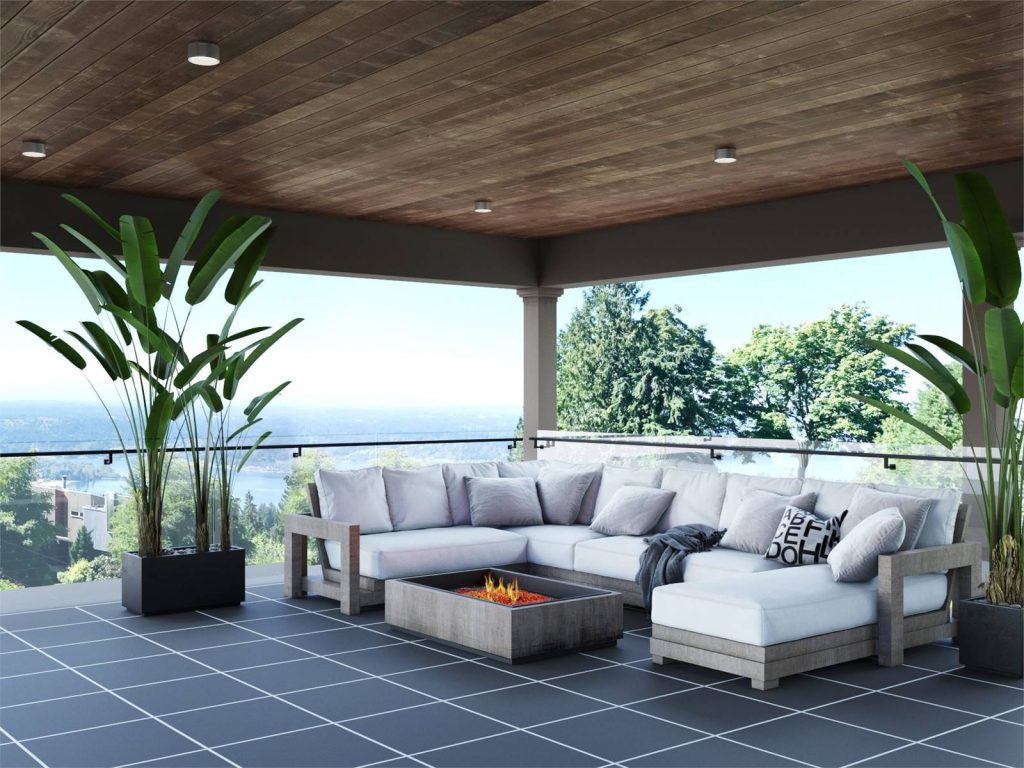 the covered outdoor living area over the garage of a luxury modern home