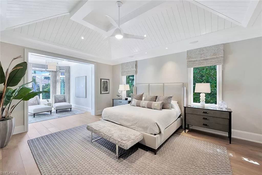 a main bedroom with a sunny sitting nook